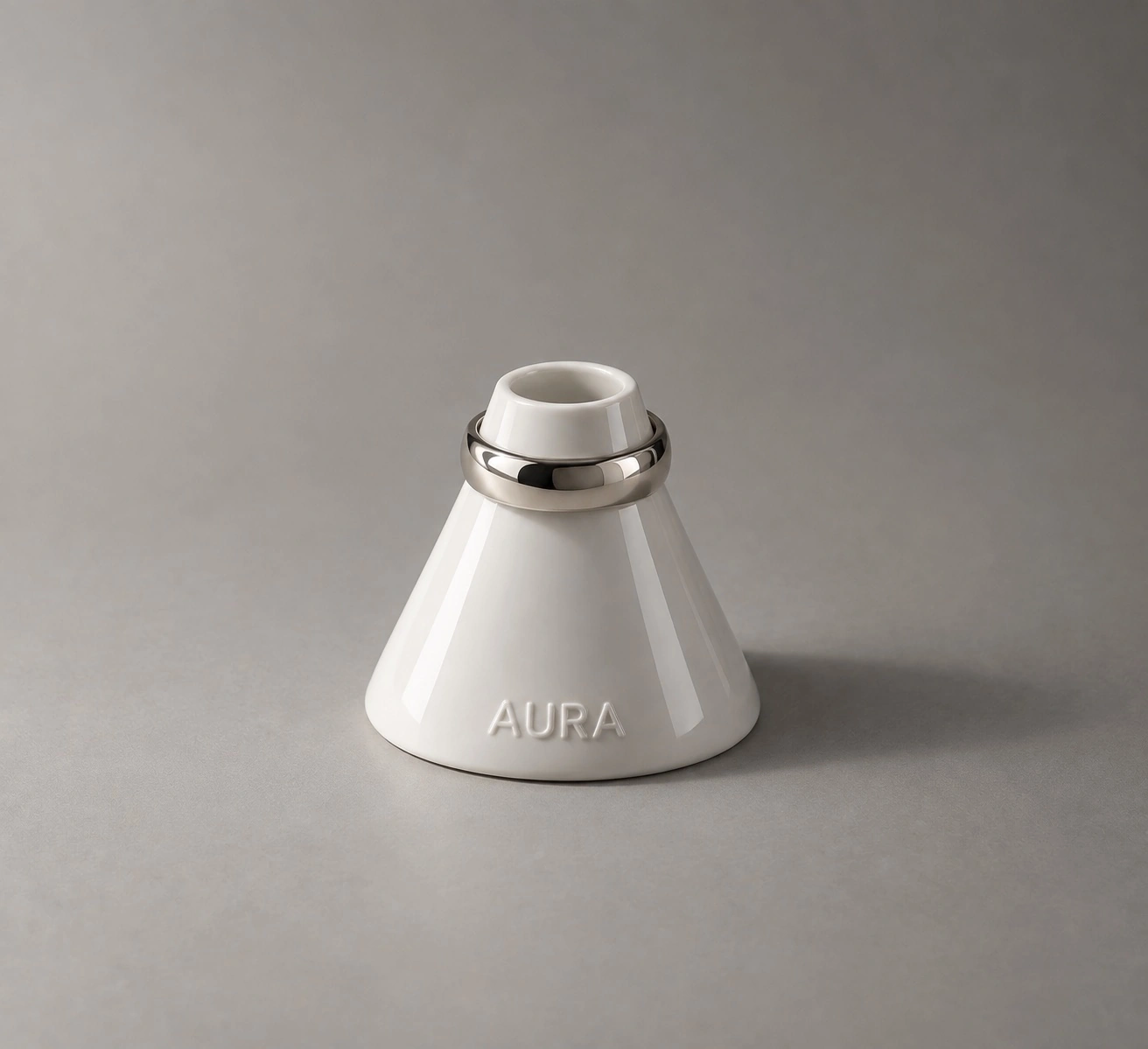 Aura white ceramic branded object with a metallic ring